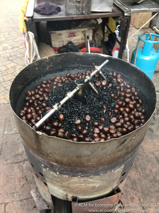 a barrel of beans being cooked
