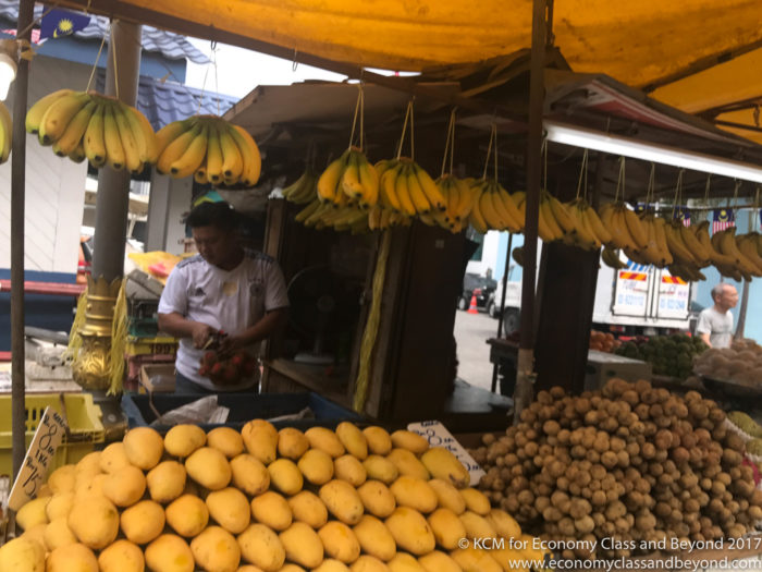 a man selling fruits at a market