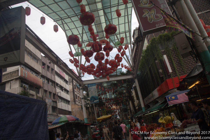 a street with red lanterns from the ceiling