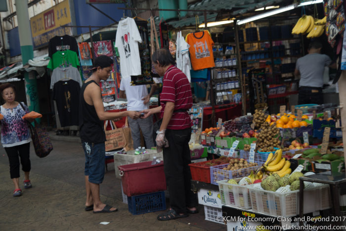 a man shaking hands with another man in a market