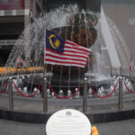 a water fountain with a flag in the middle