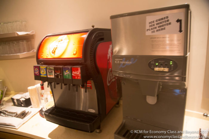 a soda machine next to a machine