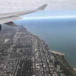 an airplane wing and a city and water