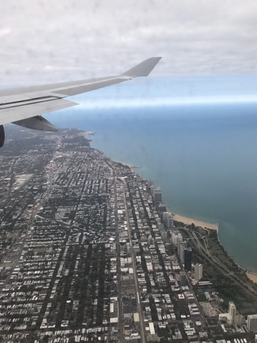 an airplane wing and a city