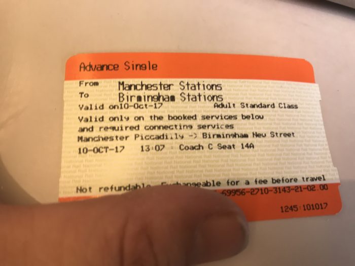 a person's finger on a ticket