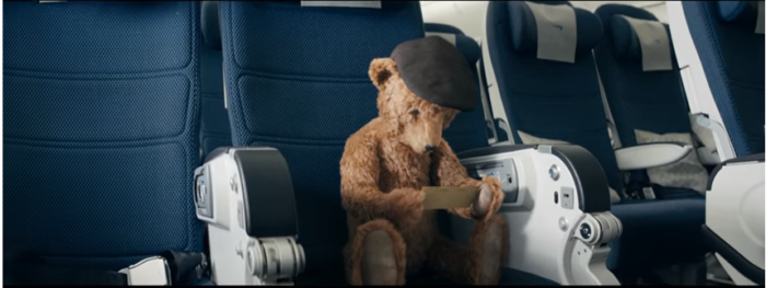 a teddy bear sitting in a plane