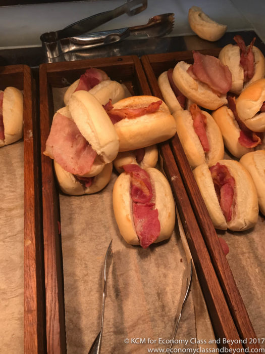 a tray of sandwiches with bacon