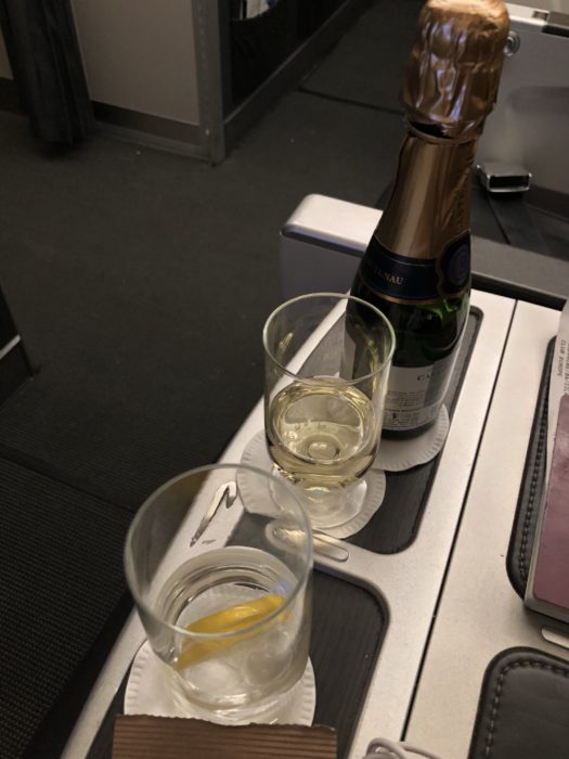 a champagne bottle and glasses on a tray