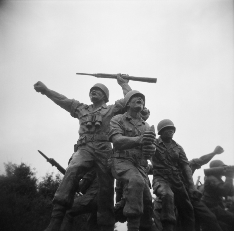 a statue of soldiers holding guns