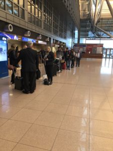 a group of people standing in a line in a terminal