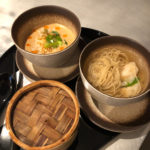 a group of bowls of soup and noodles