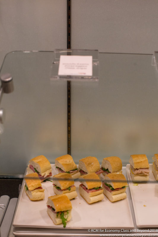 a tray of sandwiches on a glass shelf