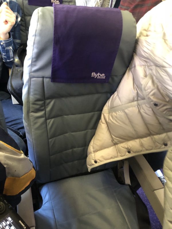 a seat with a purple towel on it