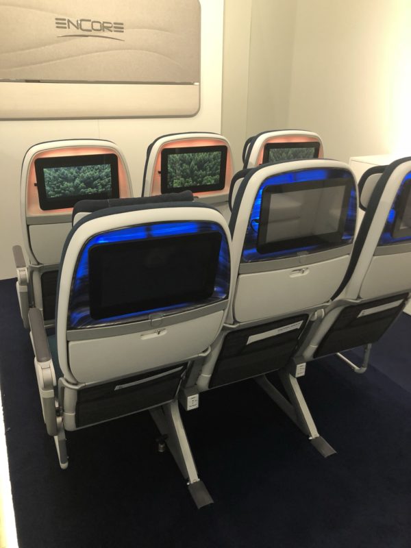 a row of seats with screens on them