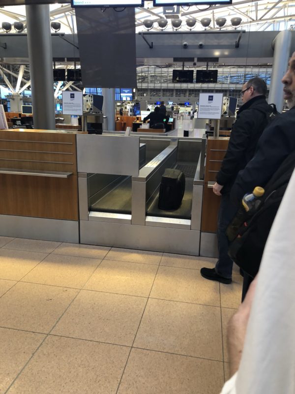people standing in front of a check-in counter