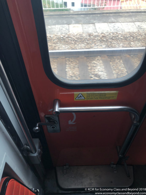 a door with a handle and a handle on a train