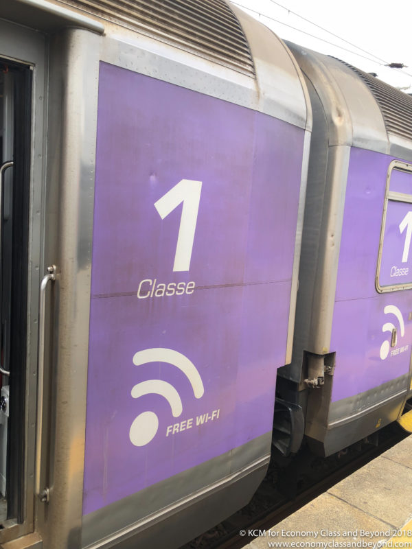 a purple train with white text and a wifi symbol on the side