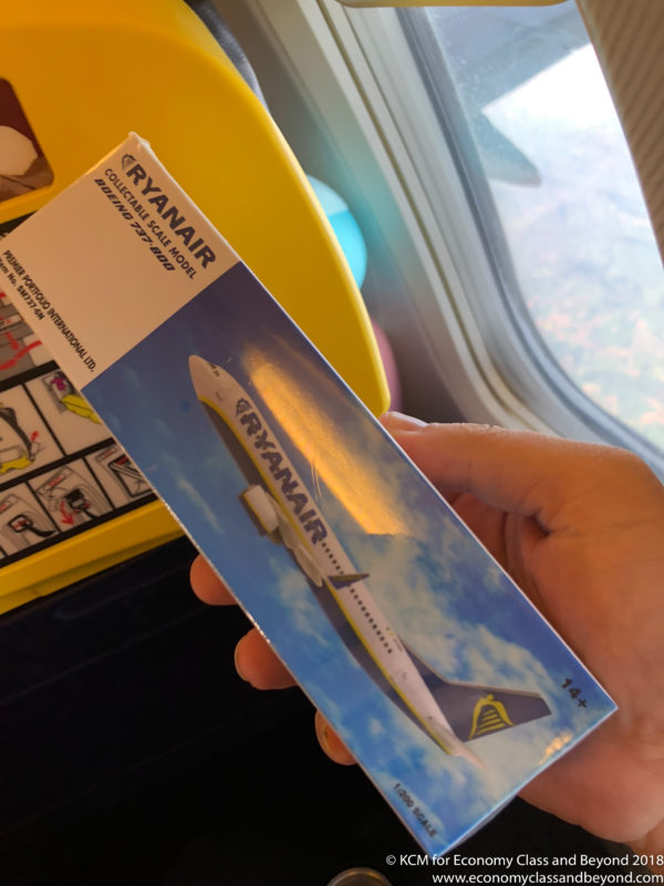 a hand holding a box with a picture of an airplane
