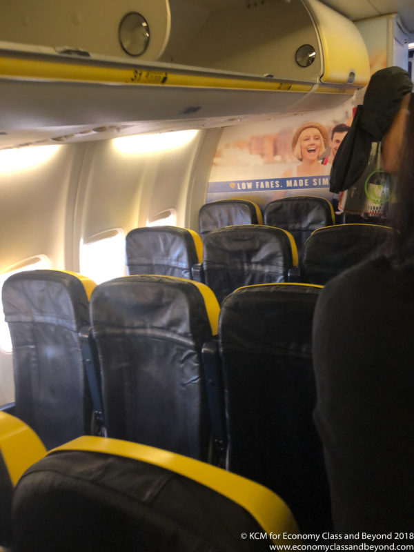 a plane with seats and a poster
