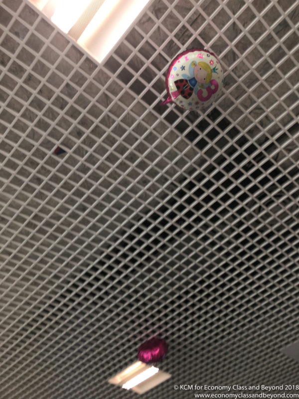a balloon on a white grid ceiling