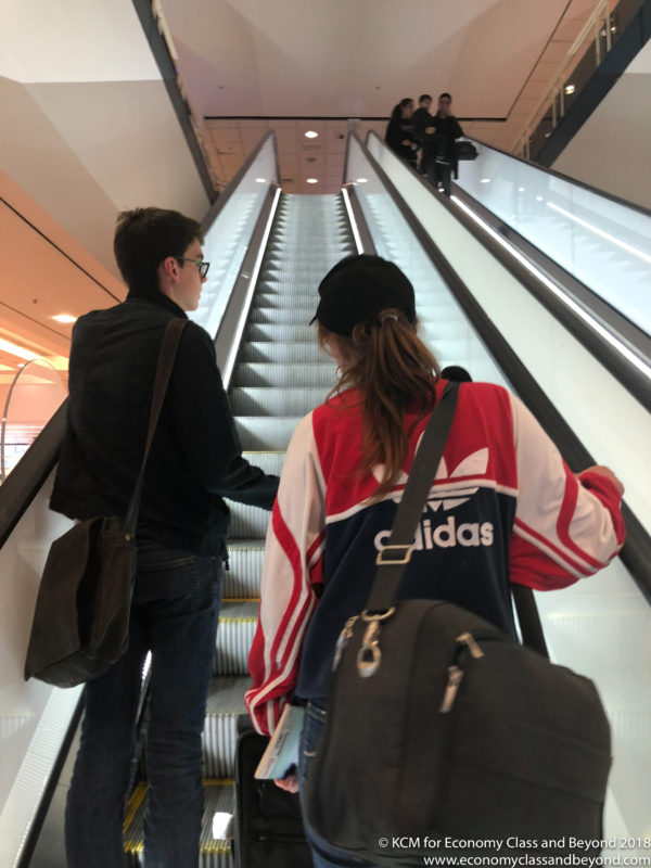 a man and woman on an escalator