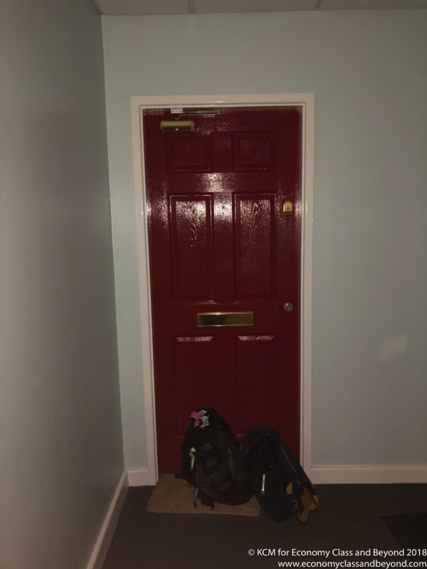 a red door with a backpack on it