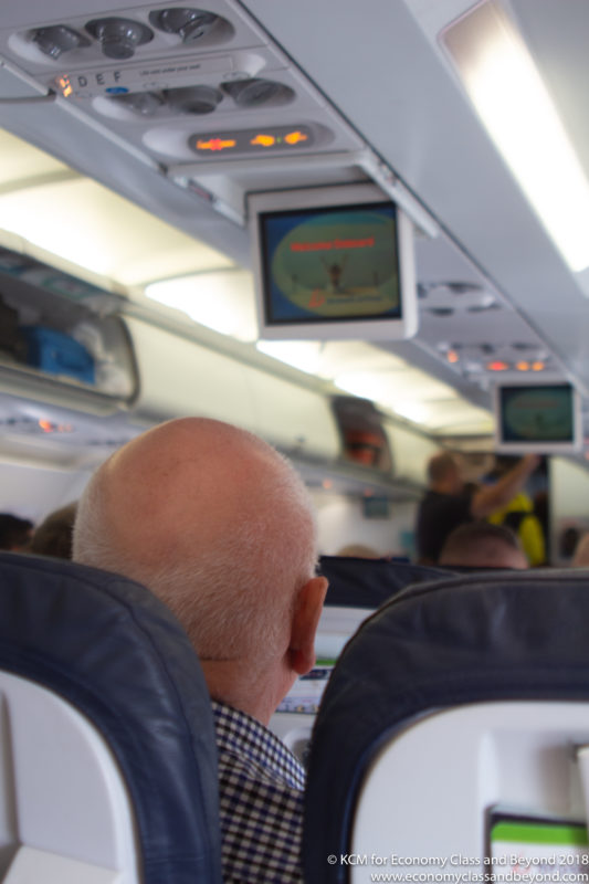 an older man sitting in an airplane
