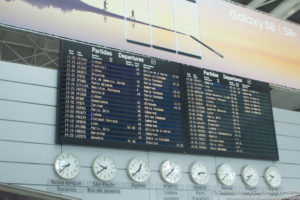 a display board with clocks and a picture of people running