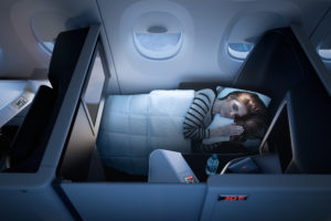 a woman sleeping in a plane