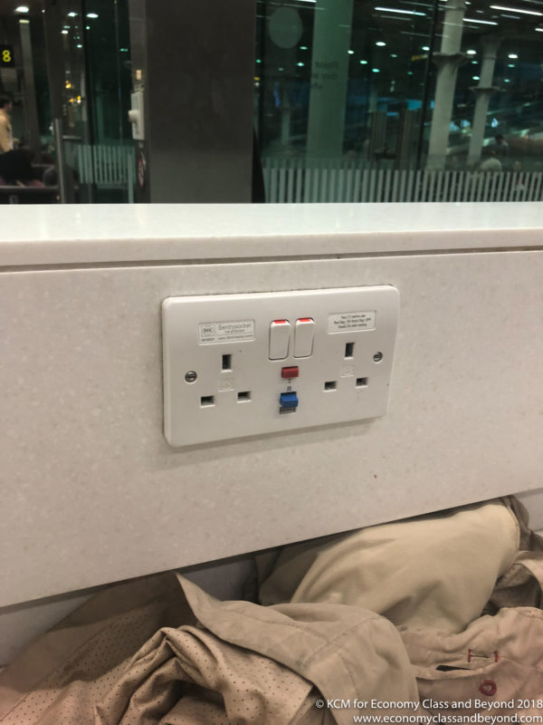 a white outlet with red buttons and blue buttons