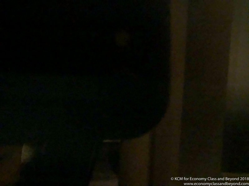a black object with a light in the background