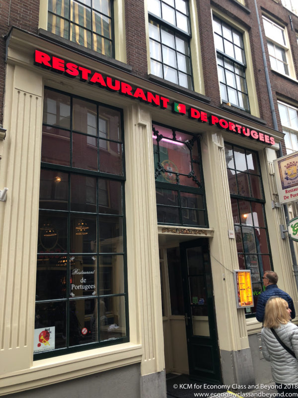 a restaurant with red letters on the front of a building