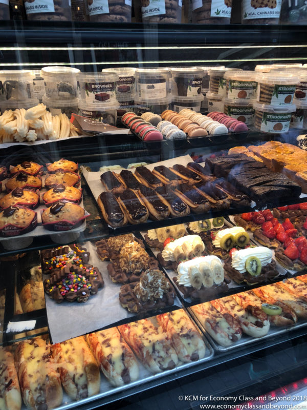 a display case of pastries and desserts