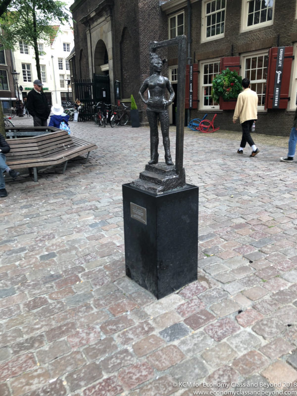 a statue of a man on a pedestal in a city