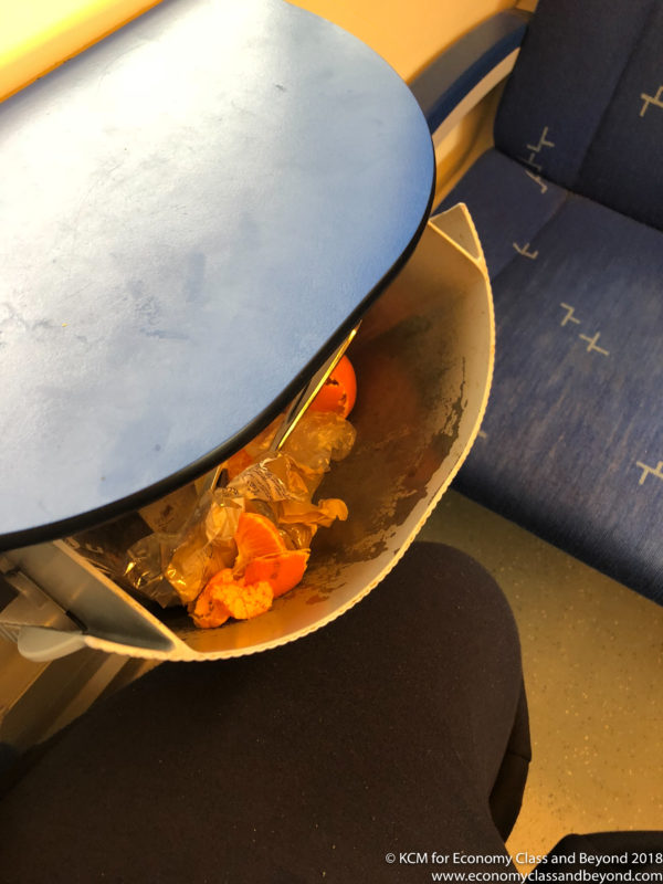 a trash can with oranges in it