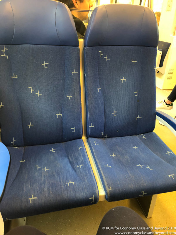 a blue seats with white crosses on it