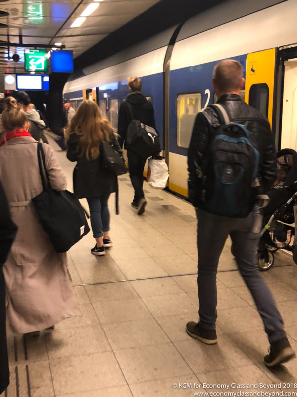 people walking on a train platform