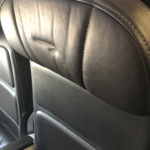 a black leather seat with a logo on it