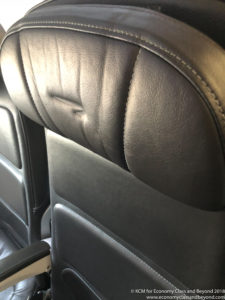 a black leather seat with a logo on it