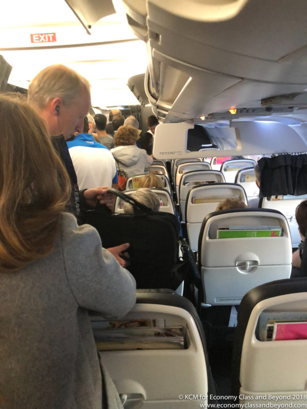 people inside of an airplane with people on the seats