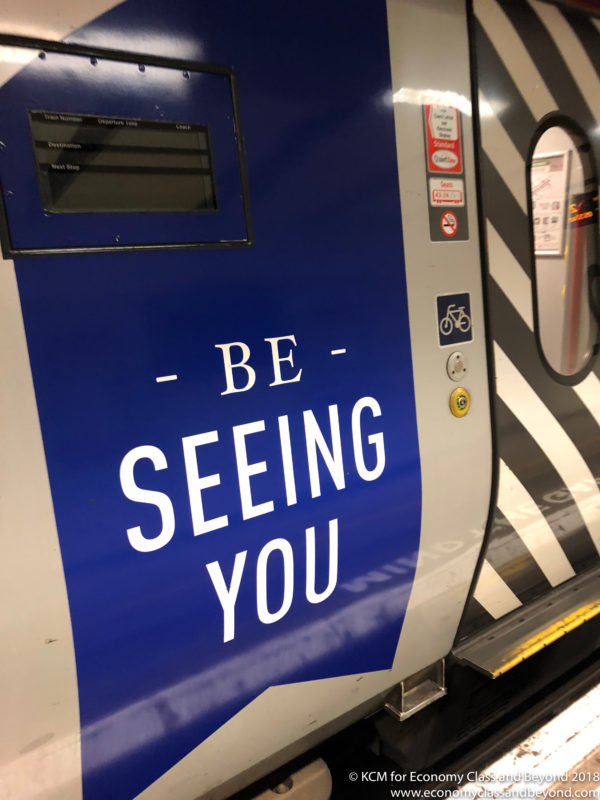 a blue and white sign on a train