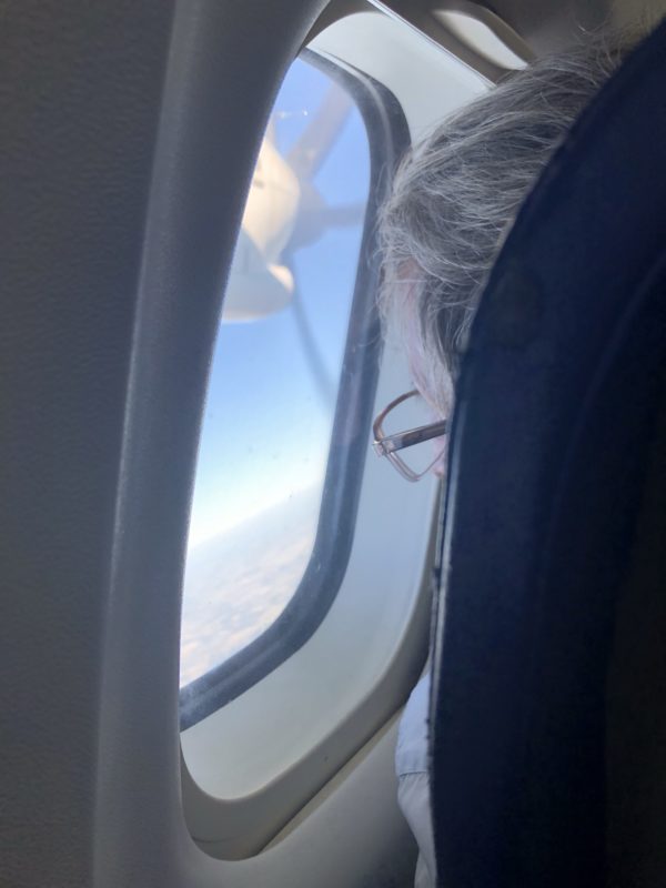 a person looking out of a window of an airplane