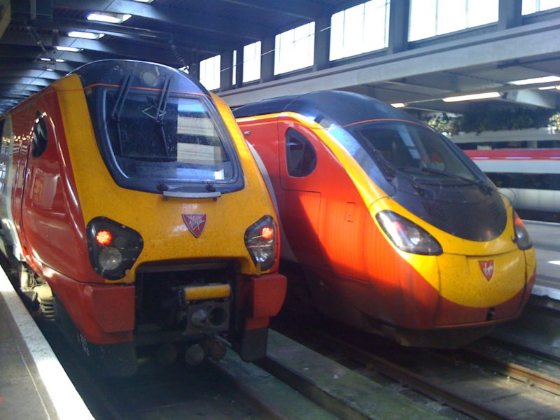 a yellow and red trains in a station