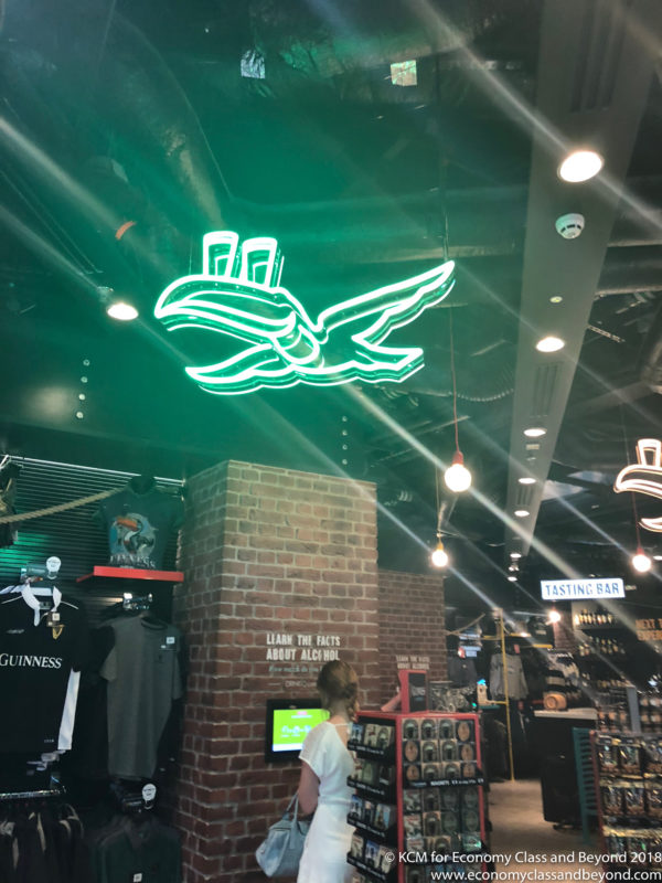 a neon sign on the ceiling of a store
