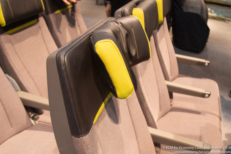 a row of chairs with black and yellow cushions