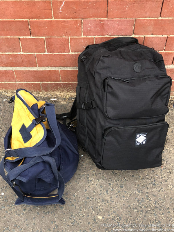 a backpacks next to a brick wall