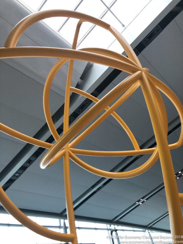 a yellow sculpture in a room