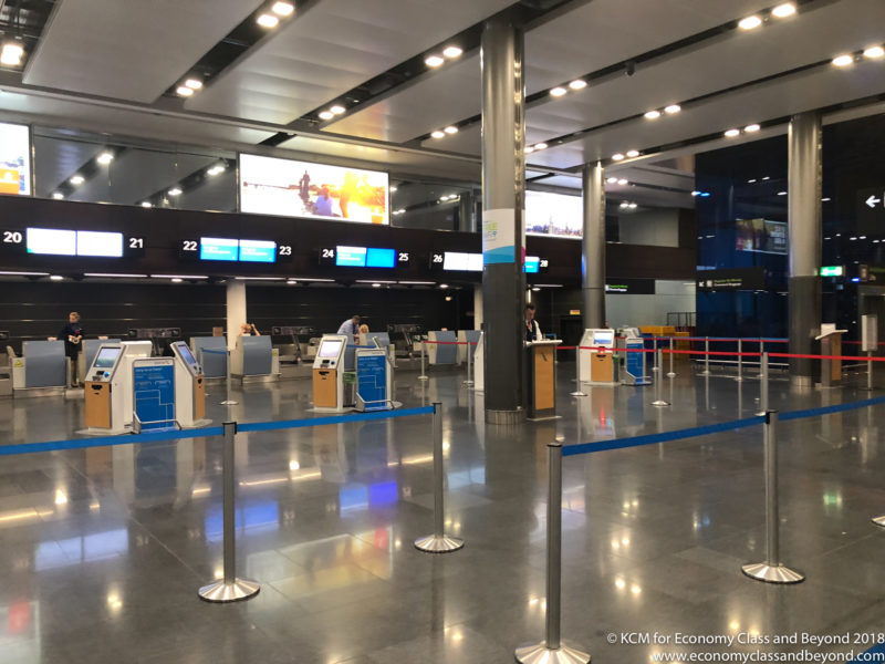 a check in area with blue and silver barriers