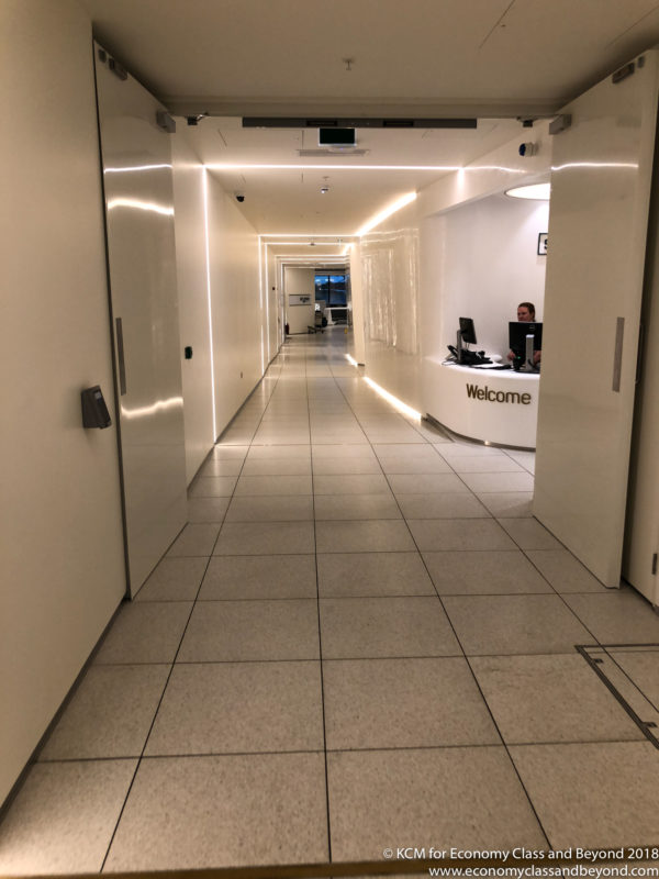 a hallway with a person at a desk