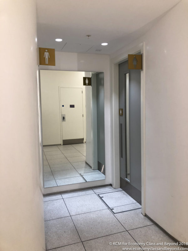 a bathroom with a mirror and a door